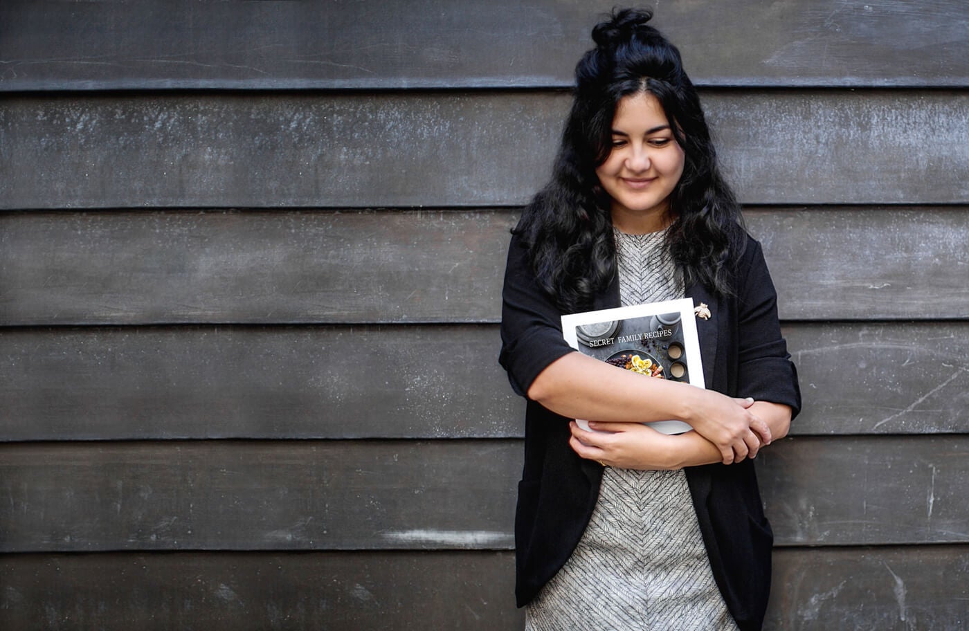 woman holding softcover photo book by printique